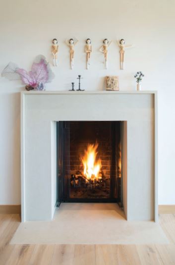 Dancing figurines add a playful touch above the hearth.