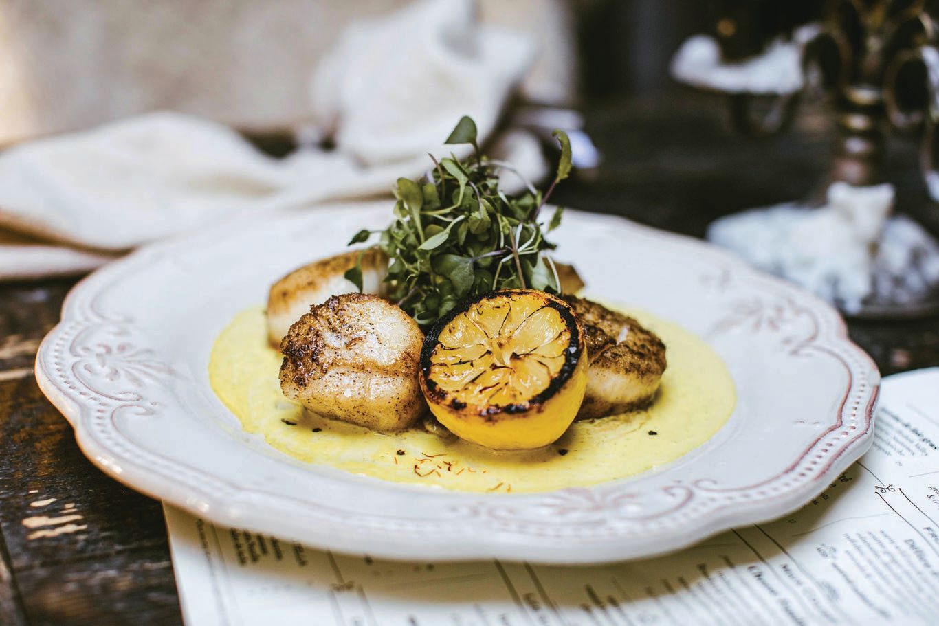 Sea scallops, with saffron lemon-butter sauce, basil and microgreens PHOTO BY AHRLING PHOTOGRAPHY