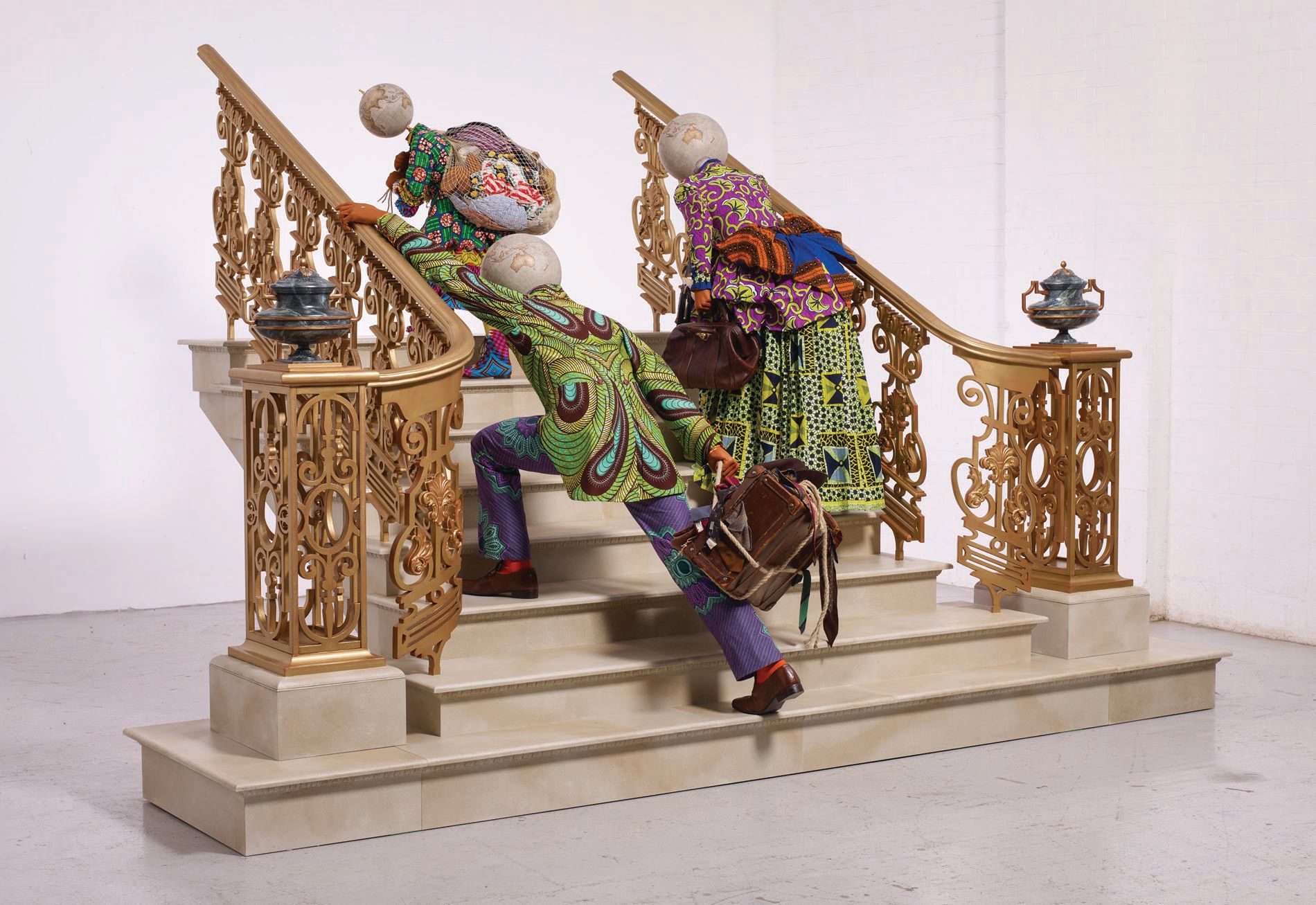 Yinka Shonibare, CBE, “Moving Up” (2021, Dutch wax printed cotton textile, bespoke globes, brass, leather, hemp rope, paper, various toys, cotton, silk, steel, aluminum and painted wood), 90 1/2 inches by 141 3/4 inches by 98 3/8 inches PHOTO: BY STEPHEN WHITE & CO./COURTESY OF THE ARTIST AND JAMES COHAN, NEW YORK
