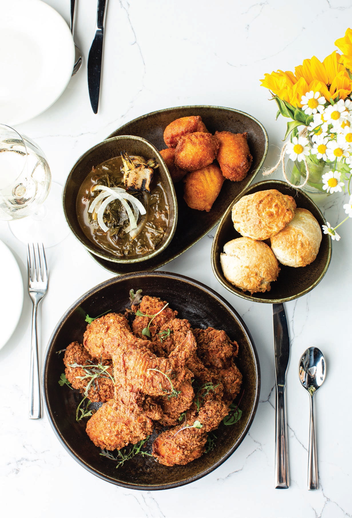 Duck fatfried chicken with Southern greens at Roots Southern Table. PHOTO BY ALYSSA VINCENT
