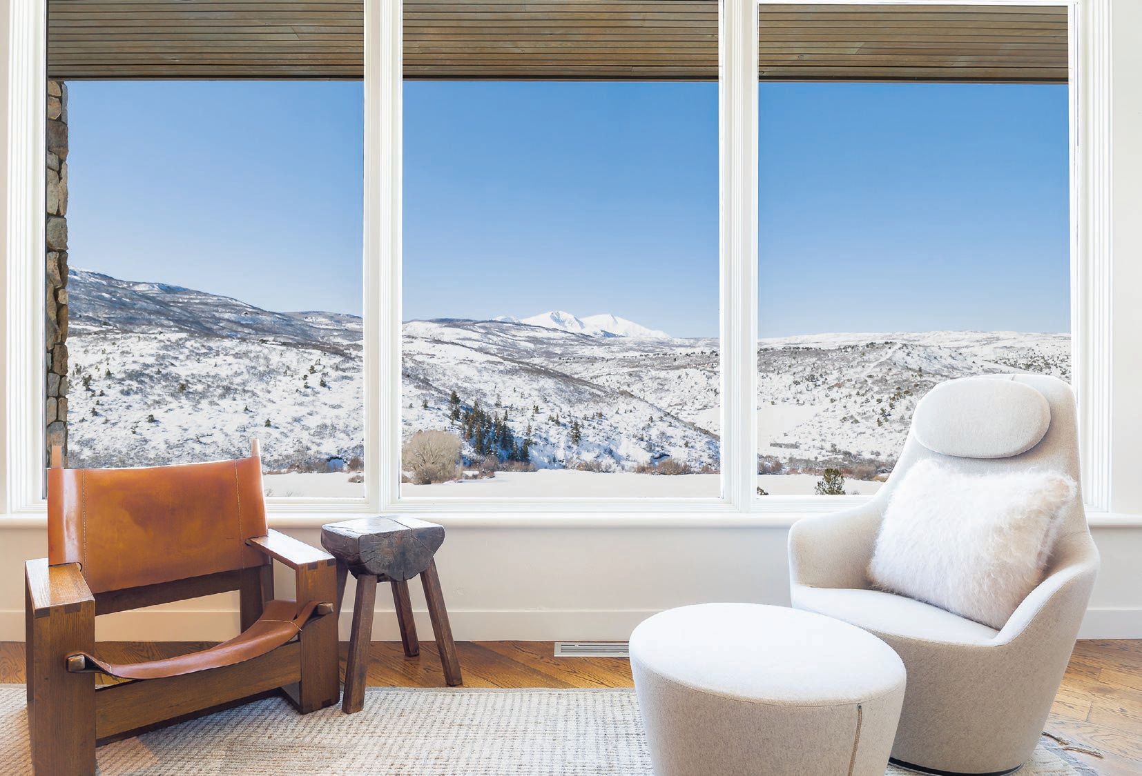 Seating area with views of iconic Mt. Sopris featuring a high-back armchair and ottoman from B&B Italia and vintage lounge chair from Nickey Kehoe PHOTOGRAPHED BY SAM FERGUSON