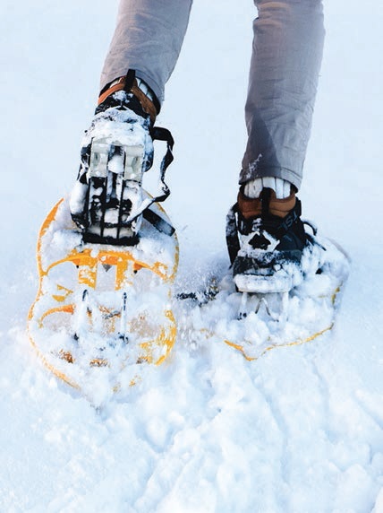 Spend the winter in the snow with activities like snowshoeing and skiing. PHOTO: BY MAEL BALLAND/UNSPLASH