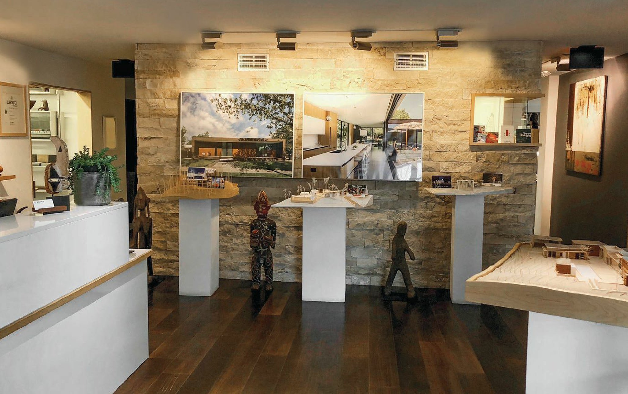 project models and photographs stand out against a dry stack stone wall in the gallerylike lobby. PHOTO COURTESY OF SCOTT LINDENAU