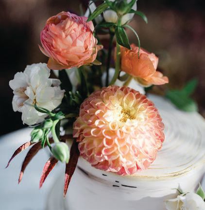 The tablescape included cafe au lait dahlias, coral charm peonies, sunset ranunculus and white scabiosa.